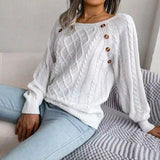 White cable-knit sweater styled with light-wash jeans, chic casual look